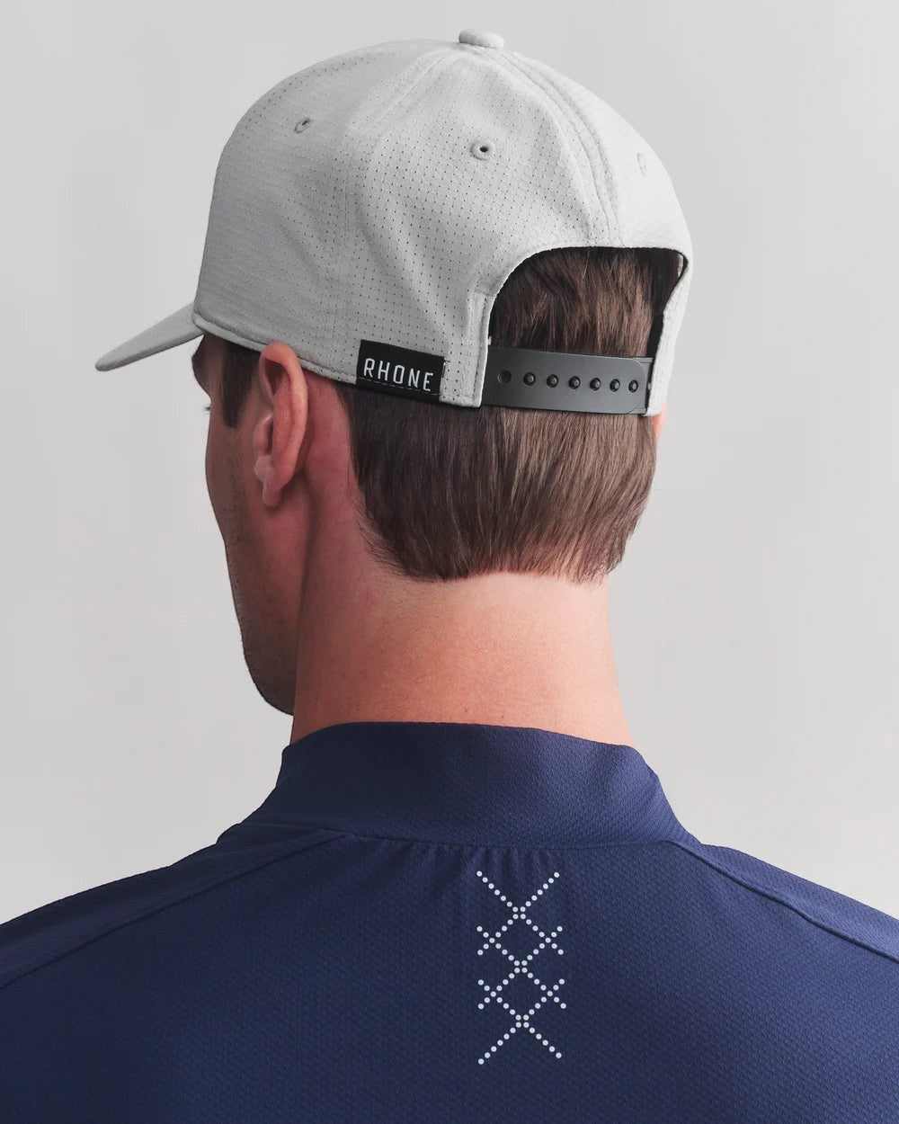 The Point Clothing Lounge's Rhone Change Up Snapback Cap in gray, a lightweight, breathable performance hat with adjustable snap closure.