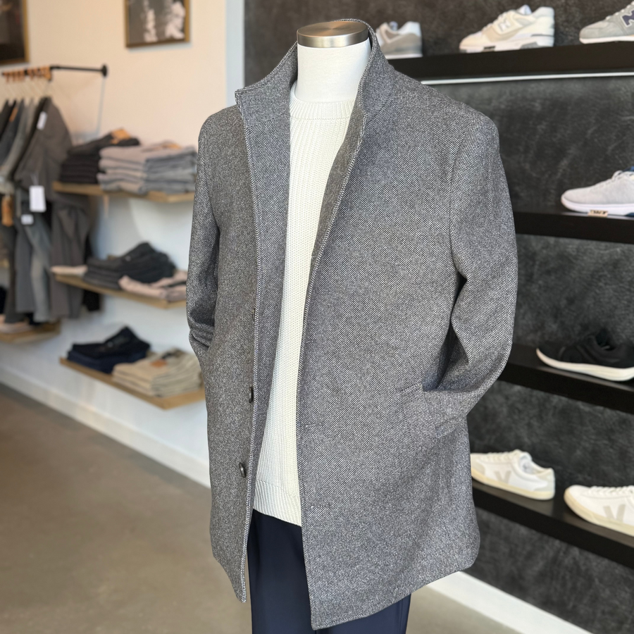 Men's wool-blend coat and knitwear display at The Point Clothing Lounge in Lynnfield, MA