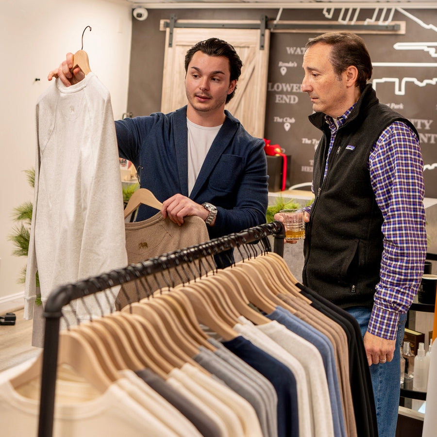 Staff member assisting a customer during a personal styling session at The Point Clothing Lounge in South Boston